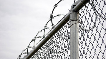 Chain link fence with razor wire on top