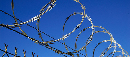 concertina razor wire under blue sky